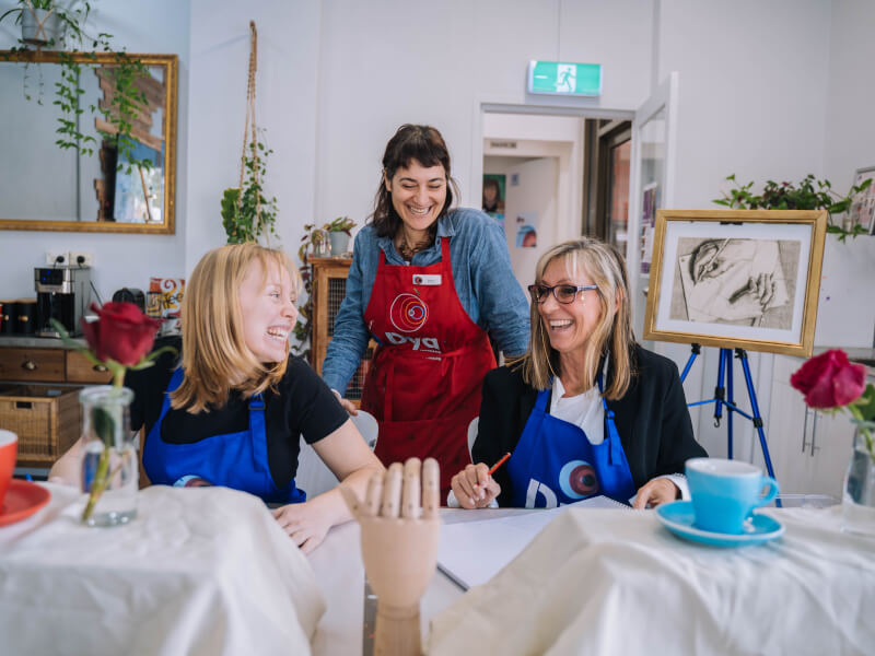 A teacher and students at a painting class